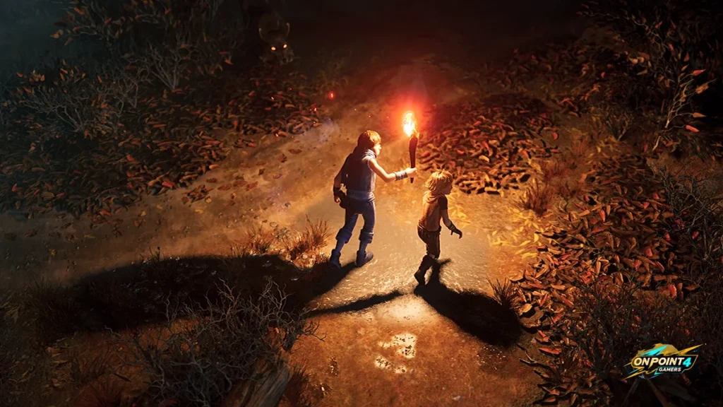 The two brothers walk a dark forest path lit by a torch in Brothers: A Tale of Two Sons Remake